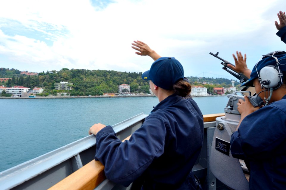 U.S. Sailors wave to people from the guided missile destroyer USS Ross (DDG 71) while transiting the Bosporus en route to the Black Sea Sept 140903-N-IY142-270