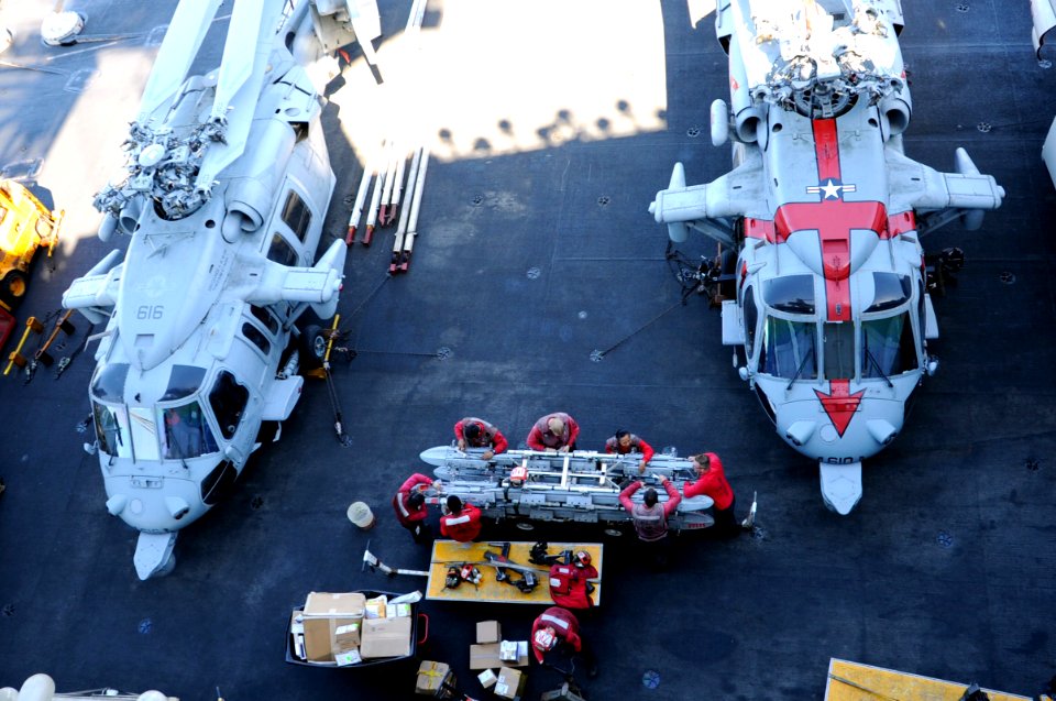 U.S. Sailors assigned to Strike Fighter Squadron (VFA) 31 clean equipment on the flight deck of the aircraft carrier USS George H.W. Bush (CVN 77) in the Persian Gulf Oct. 20, 2014 141020-N-MU440-063