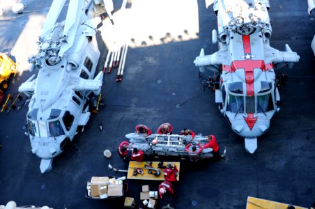 U.S. Sailors assigned to Strike Fighter Squadron (VFA) 31 clean equipment on the flight deck of the aircraft carrier USS George H.W. Bush (CVN 77) in the Persian Gulf Oct. 20, 2014 141020-N-MU440-063