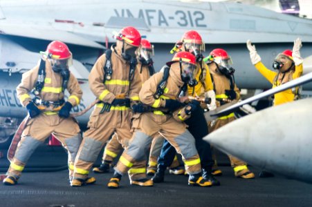 U.S. Sailors fight a simulated fire during a general quarters drill in the hangar bay of the aircraft carrier USS Harry S. Truman (CVN 75) March 8, 2014, in the Gulf of Oman 140308-N-ZG705-530