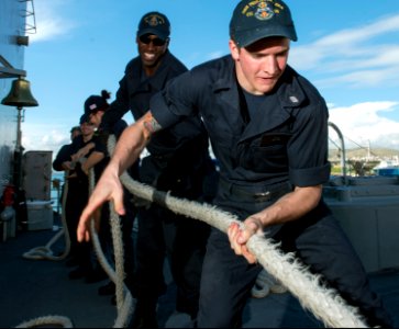 U.S. Sailors heave a line aboard the guided missile cruiser USS Philippine Sea (CG 58) as it pulls out of Piraeus, Greece, March 7, 2014 140307-N-PJ969-028 photo