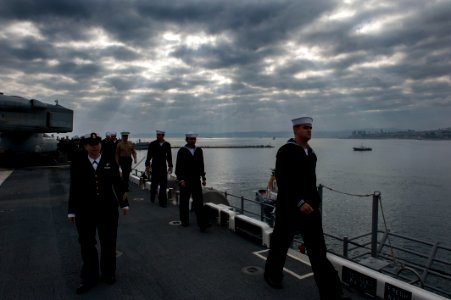 U.S. Sailors and Marines prepare to man the rails as the amphibious assault ship USS America (LHA 6) departs Valparaiso, Chile, Aug. 27, 2014, after a three-day port visit 140827-N-MZ309-006