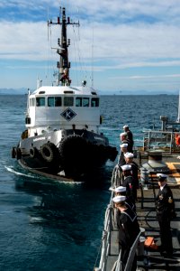 U.S. Sailors man the rails aboard the guided missile cruiser USS Philippine Sea (CG 58), right, March 4, 2014, as it arrives in Athens, Greece, for a scheduled liberty port visit 140304-N-PJ969-260