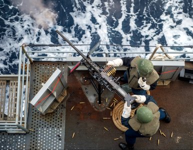 U.S. Sailors assigned to the amphibious transport dock ship USS Denver (LPD 9) fire a .50-caliber machine gun during a live-fire exercise March 10, 2014, in the East China Sea 140310-N-ZU025-293