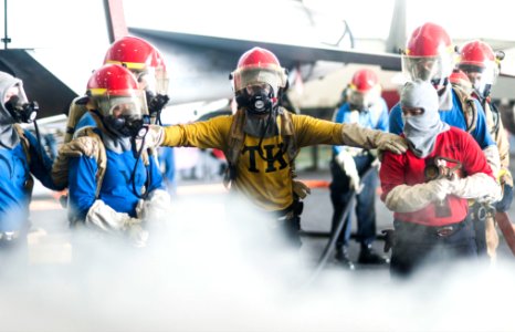 U.S. Sailors fight a simulated fire during a general quarters drill in the hangar bay of the aircraft carrier USS Harry S. Truman (CVN 75) March 8, 2014, in the Gulf of Oman 140308-N-ZG705-462