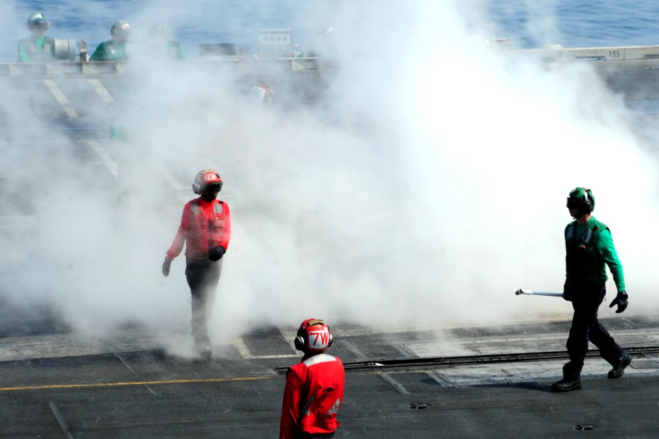 U.S. Sailors prepare to launch aircraft on the flight deck of the aircraft carrier USS George H.W. Bush (CVN 77) in the Persian Gulf Oct. 18, 2014, as the ship supports Inherent Resolve 141018-N-CZ979-008