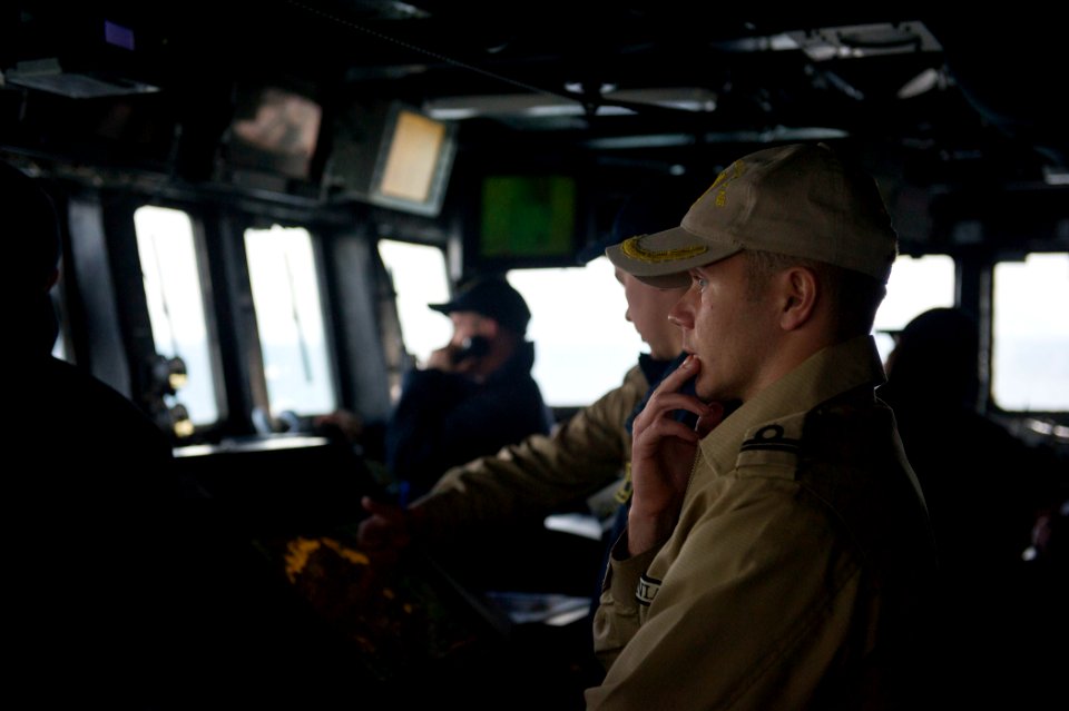 U.S. Sailors assigned to the guided missile destroyer USS Truxtun (DDG 103) work with Romanian sailors on the ship's bridge while underway in the Bosphorus strait March 7, 2014 140307-N-EI510-088