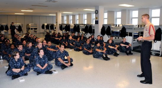 U.S. Navy recruits with the Recruit Training Command at Naval Station Great Lakes in Illinois listen to a presentation by Petty Officer 2nd Class Chris Shaw, right, their recruit division commander, Sept 110908-N-IK959-576