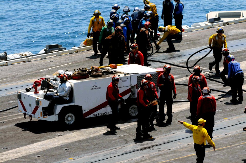 U.S. Sailors organize fire hoses June 27, 2014, during a general quarters drill on the flight deck of the aircraft carrier USS George H.W. Bush (CVN 77) in the Persian Gulf 140627-N-CZ979-036