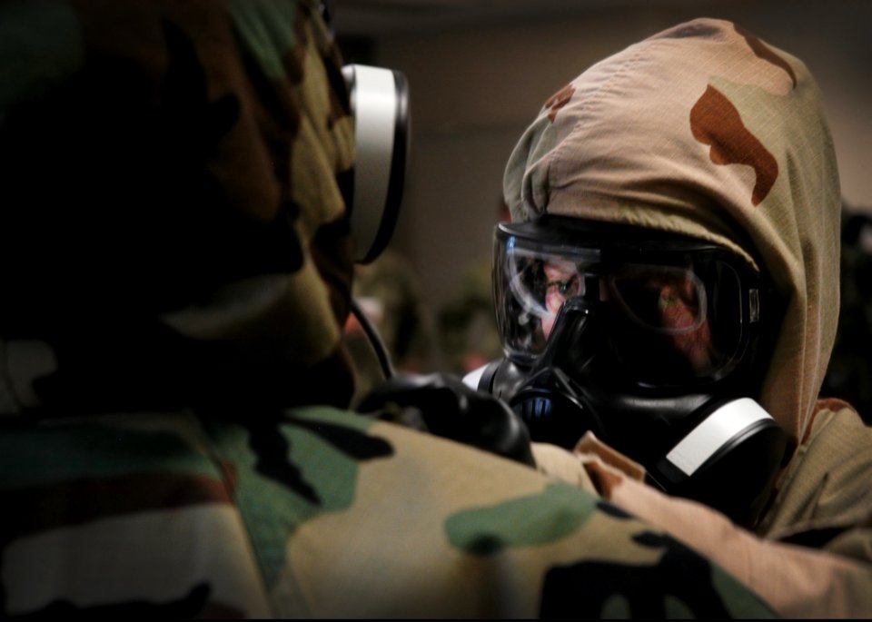 U.S. Sailors with Naval Mobile Construction (NMCB) 25 check each other's mission-oriented protective posture gear during a simulated chemical attack during chemical, biological and radiological (CBR) team 140214-N-JP566-045