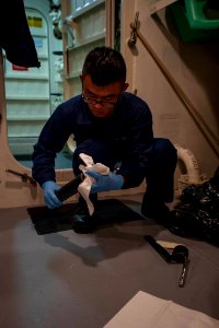 U.S. Navy Seaman Shilong Zhou organizes cleans a grease gun aboard the amphibious assault ship USS America (LHA 6) Sept 140905-N-MZ309-012