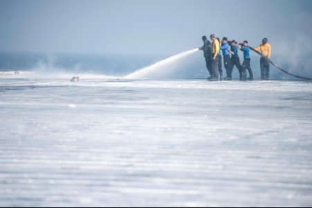 U.S. Sailors wash the flight deck of the aircraft carrier USS Harry S. Truman (CVN 75) March 16, 2014, in the Gulf of Oman 140316-N-ZG705-468
