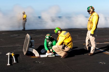 U.S. Sailors prepare a catapult to launch an aircraft on the flight deck of the aircraft carrier USS Harry S. Truman (CVN 75) in the Gulf of Oman March 14, 2014 140314-N-ZG705-021