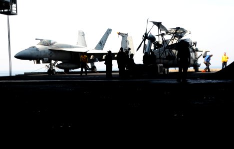U.S. Sailors prepare to move aircraft into the hangar bay aboard the aircraft carrier USS George H.W. Bush (CVN 77) June 30, 2014, in the Persian Gulf 140630-N-MU440-035