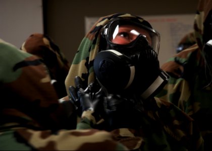 U.S. Sailors with Naval Mobile Construction Battalion (NMCB) 25 check each other's mission-oriented protective posture gear during a simulated chemical attack during chemical, biological and radiological (CBR) 140214-N-JP566-050