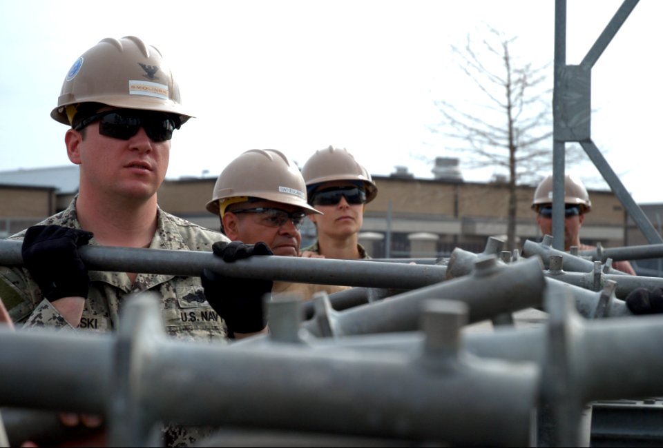 U.S. Sailors with Naval Mobile Construction Battalion (NMCB) 25 and NMCB-11 remove a transom cross girder from a truss bridge during bridge construction training in Gulfport, Miss., Feb. 25, 2014 140225-N-JP566-028