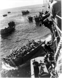 U.S. troops going over the side of a combat transport to enter the landing barges at Empress Augusta bay, Bougainville. LCCN2016647174