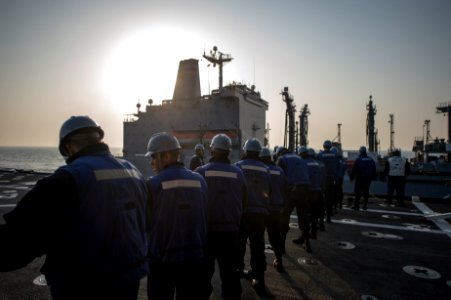 U.S. Sailors assigned to the amphibious transport dock ship USS Denver (LPD 9) stand by after towing in a line during a replenishment at sea with the fleet replenishment oiler USNS Rappahannock (T-AO 204) in 140327-N-ZU025-083