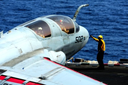 U.S. Sailors direct an EA-6B Prowler aircraft assigned to Electronic Attack Squadron (VAQ) 134 on the flight deck of the aircraft carrier USS George H.W. Bush (CVN 77) Aug. 26, 2014, in the Persian Gulf as 140826-N-CZ979-007
