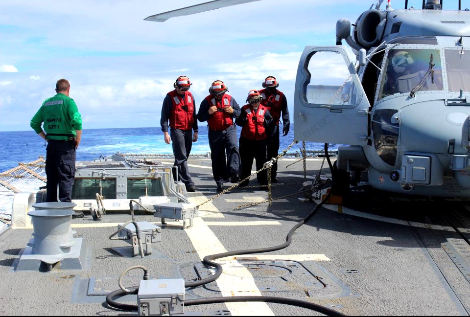 U.S. Sailors inspect the flight deck of the guided missile destroyer USS Kidd (DDG 100) in the Indian Ocean March 16, 2014 140316-N-ZZ999-002