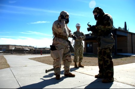U.S. Sailors with Naval Mobile Construction Battalion (NMCB) 25 prepare to test air quality with an M256 chemical agent detector kit during a simulated chemical attack during chemical, biological 140214-N-JP566-103