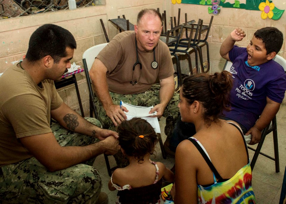 U.S. Service members tend to Guatemalan patients at a medical civic action project (MEDCAP) in Puerto Barrios, Guatemala, Aug. 23, 2014, during Southern Partnership Station (SPS) 2014 140823-N-QY430-499