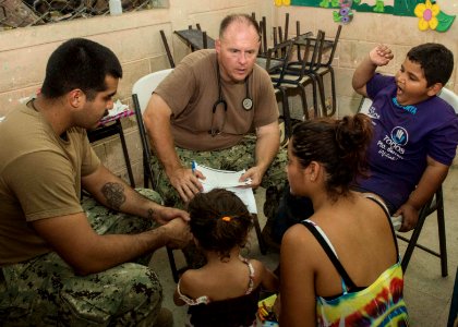 U.S. Service members tend to Guatemalan patients at a medical civic action project (MEDCAP) in Puerto Barrios, Guatemala, Aug. 23, 2014, during Southern Partnership Station (SPS) 2014 140823-N-QY430-499