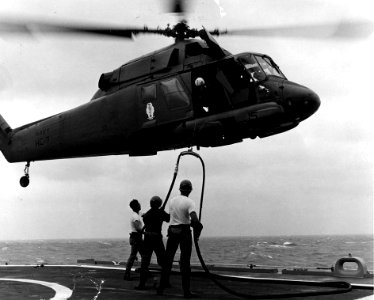 UH-2 Seasprite HC-7 being refueled from ship off Vietnam c1970