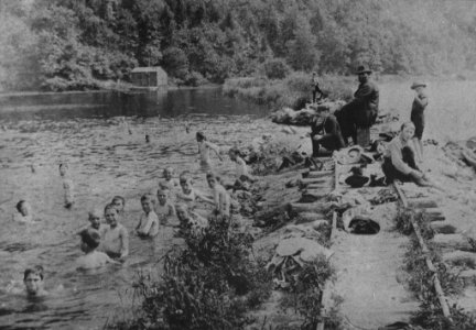 Uncle Abram Hallenback supervises swimming kids at Annaville Creek near Peekskill, New York