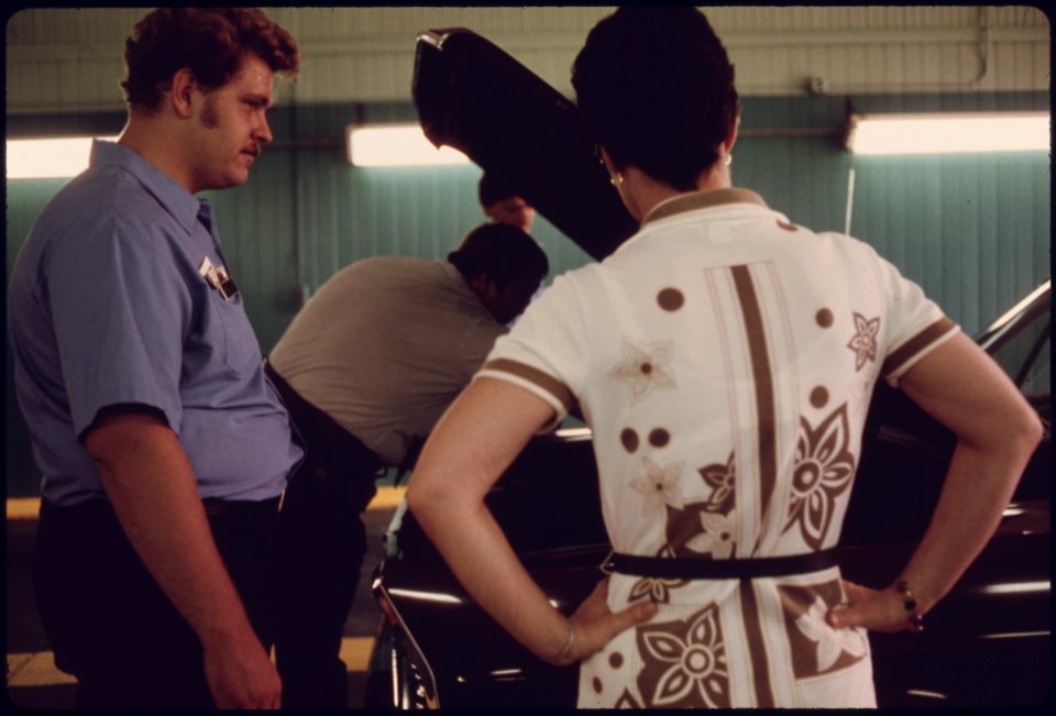 Unhappy Car Owner, Foreground, Watches as Public Works Department Employees Try to Locate the Reason Her Vehicle Failed Its Inspection for the Second Time at an Auto Emission Inspection Station at Norwood, Ohio...08-1975 (4266528354)