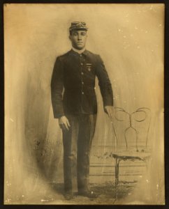 Unidentified African American soldier, 9th cavalry, full-length portrait, standing, facing front, wearing uniform with marksman badge and sharpshooters medal, and kepi with crossed sabers LCCN2002719505
