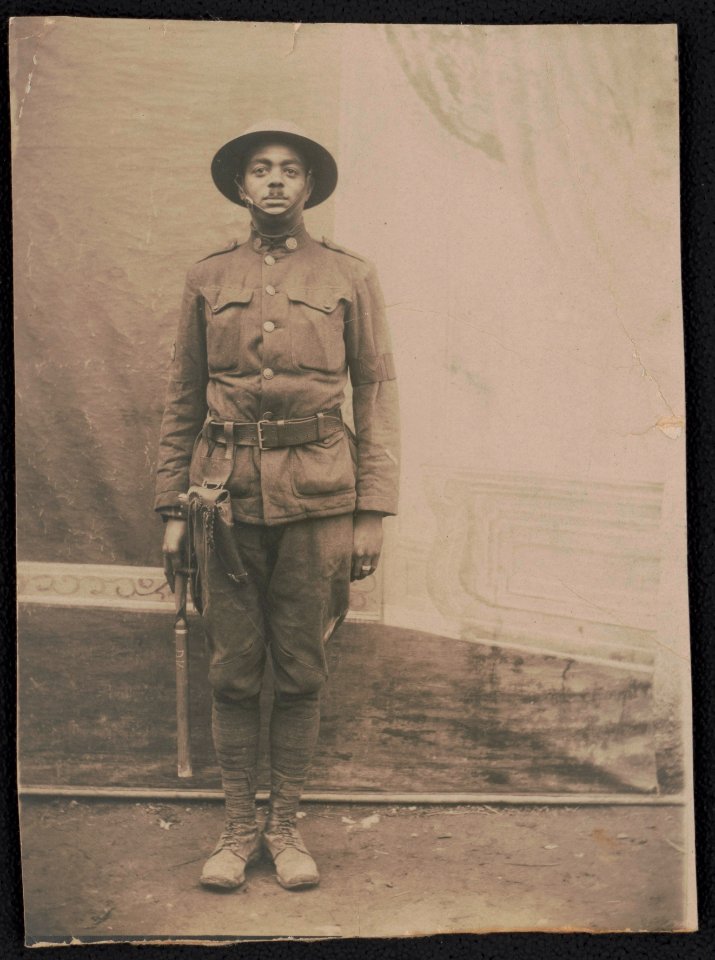 Unidentified African American military policeman in uniform and helmet with holstered handgun and billy club LCCN2017648708