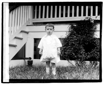 Unidentified child standing in front of porch LOC npcc.04224