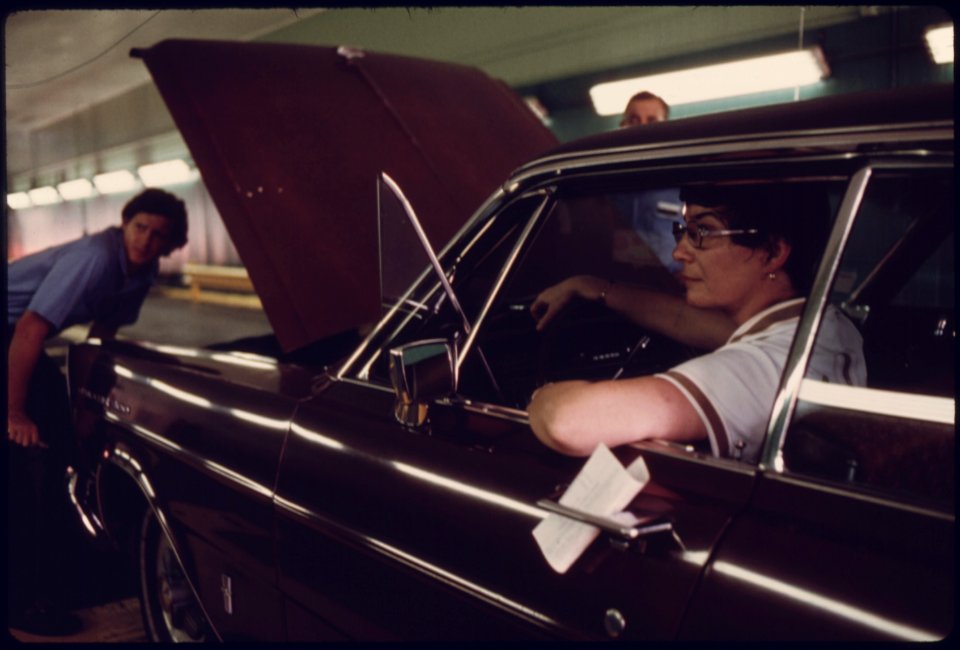 Unhappy Car Owner, Foreground, Watches as Public Works Department Employees Try to Locate the Reason Her Vehicle Failed Its Inspection for the Second Time at an Auto Emission Inspection Station at Norwood, Ohio...08-1975 (4266528208)