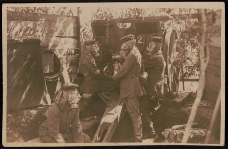 Unidentified German soldiers in uniform with gas masks loading cannon LCCN2018646051