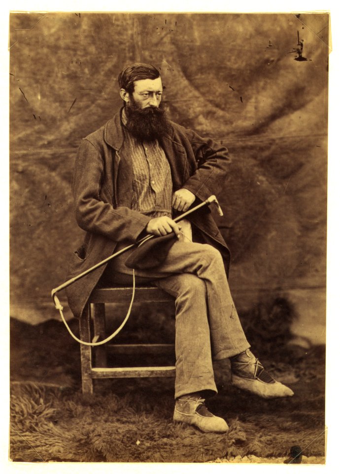 Unidentified man, possibly John Keast Lord, naturalist with the Commission survey, full-length portrait, seated, facing right, holding dog whip LCCN2005680431