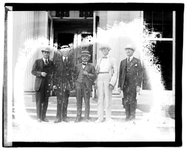 Unidentified men standing on steps of office building LOC npcc.04697