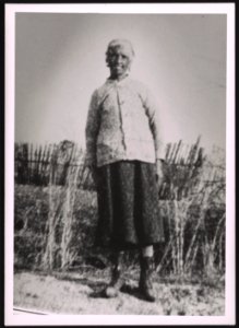 Unidentified older woman standing on dirt road LCCN2015650132