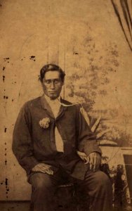 Unidentified seated Hawaiian man, photograph by H. L. Chase, Mission Houses Museum Archives
