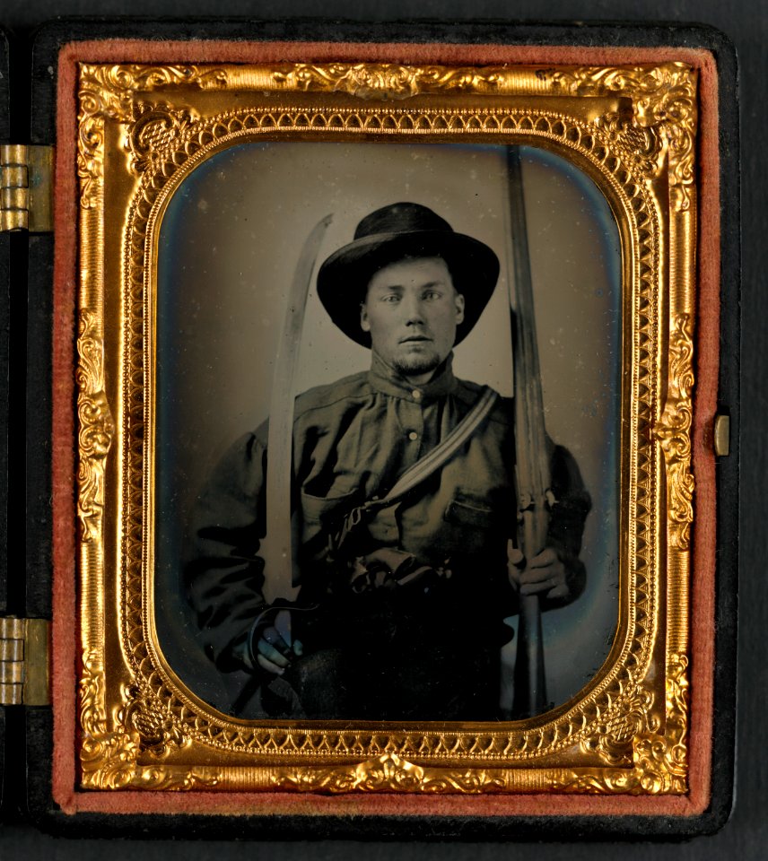 Unidentified soldier in Confederate uniform with double barrel shotgun, Bowie knife, and two pistols LCCN2015645466