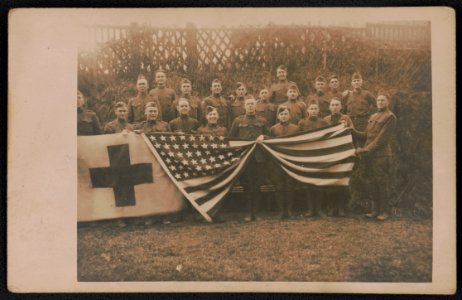 Unidentified soldiers of Army medical company in uniform with American flag and red cross banner LCCN2018645975