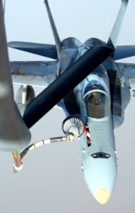 US Navy 030321-F-7203T-004 A U.S. Navy F-A-18 Hornet takes fuel from an Air Force KC-135 Stratotanker in the skies near Iraq