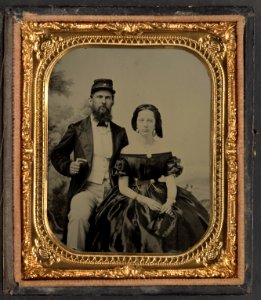 Unidentified soldier from a Charleston militia unit in kepi with letter M and unidentified woman painted backdrop showing trees and a landscape) - Quinby & Co., artists, Charleston, S.C LCCN2014647471