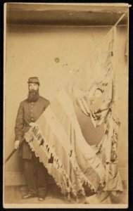 Unidentified soldier in Union uniform displaying tattered 7th Connecticut Infantry Regiment flag) - Beers & Mansfield, National Gallery, 242 Chapel Street, New Haven, Conn LCCN2016651691