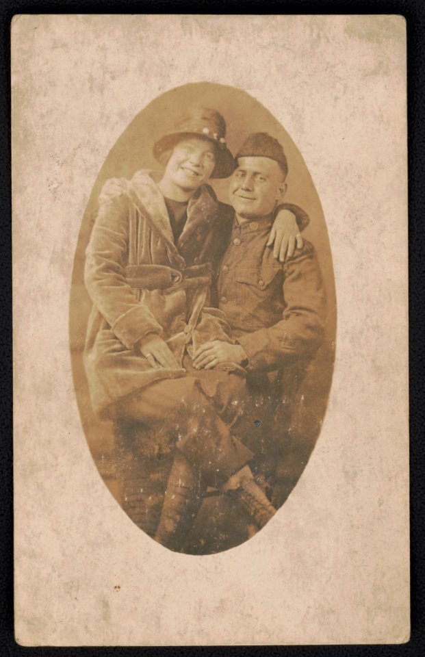 Unidentified soldier in uniform with unidentified woman sitting on his lap LCCN2018645966 photo