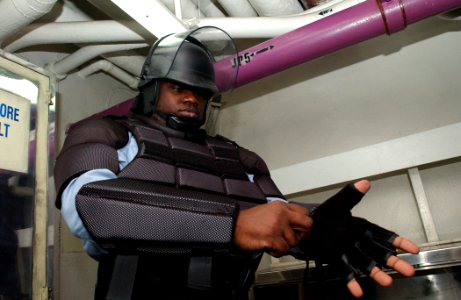 US Navy 030322-N-1328C-501 Master-at-Arms 2nd Class Robert Butler from Florence, S.C., dresses out in riot gear for a training exercise