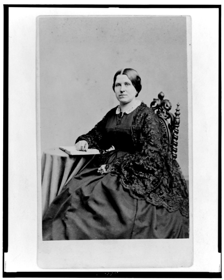 Unidentified woman, three-quarter length portrait, seated with hand on book, facing left LCCN98506731