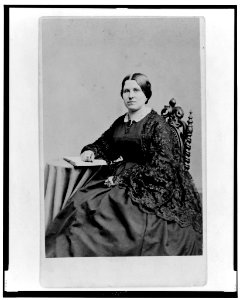 Unidentified woman, three-quarter length portrait, seated with hand on book, facing left LCCN98506731