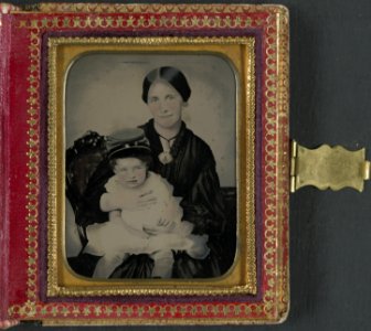 Unidentified woman, possibly Mrs. James Shields, in mourning dress and brooch showing Confederate soldier and holding young boy wearing kepi LCCN2013649140