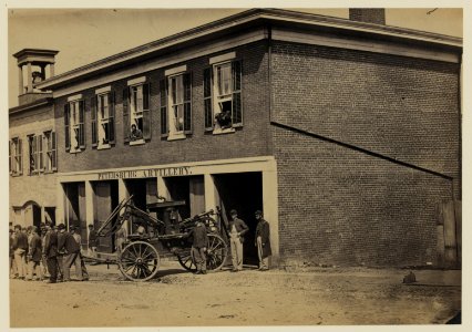 Union soldiers pull a fire engine from a garage designated Petersburg artillery LCCN2005684445